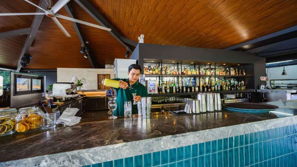 Bartender preparing craft cocktails at the Piece of Sky rooftop bar, H Hotel El Nido