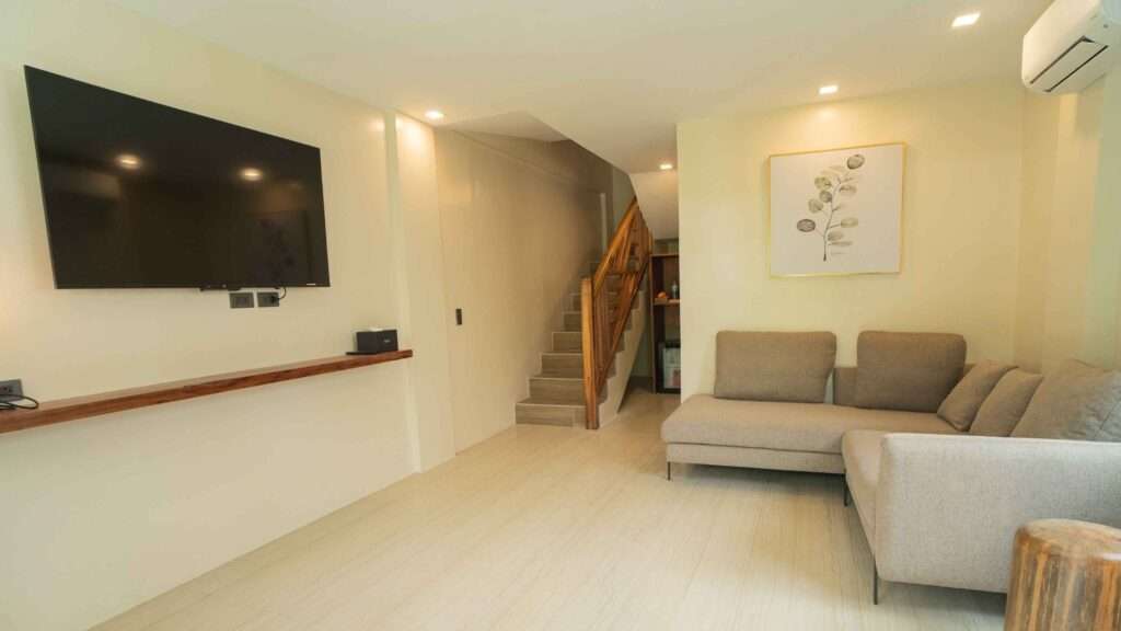 Living room and staircase inside a duplex villa at Nacpan Beach Villas, El Nido