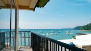 Balcony of the Executive Suite at S Resort El Nido overlooking turquoise water and moored boats