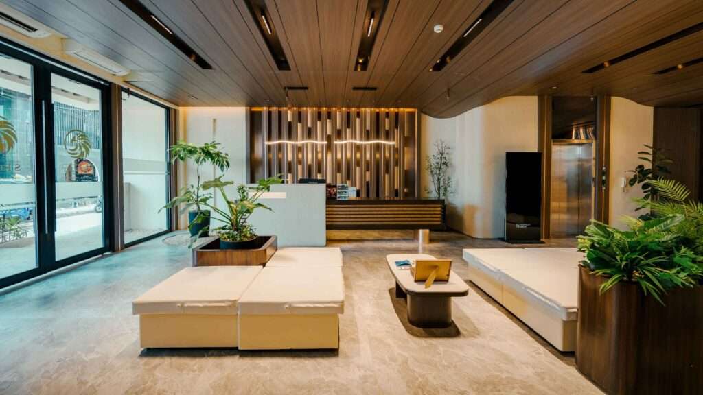 Lobby at S Resort El Nido with timber ceiling, seating and tropical planting after renovation